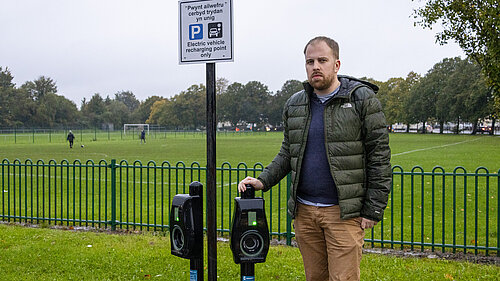 Cadan stood by an EV charger